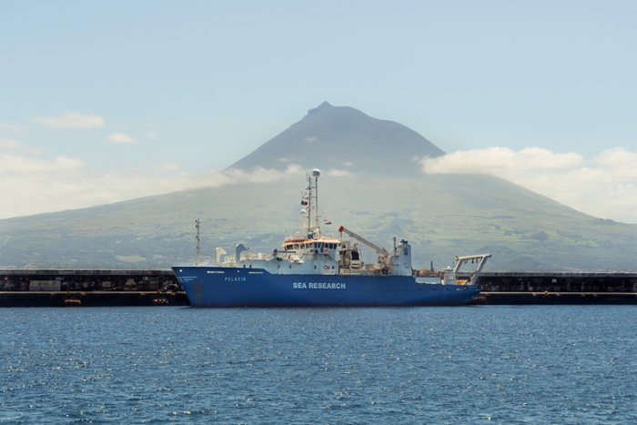 Research vessel Pelargia moored off the coast of  the Azores. In the background the Pico volcano.
