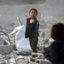 Palestijnen inspecteren het puin van een school na een bombardement in Jabalia in het noorden van Gaza, 12 mei 2025 