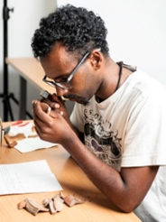 Sam Botan studying pottery from the ancient Aksumite Empire