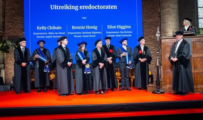 A group of people in gowns on a stage.