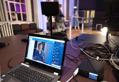 A laptop showing Annetje Ottow being interviewed by fellow law alumnus Bastiaan Rijpkema.