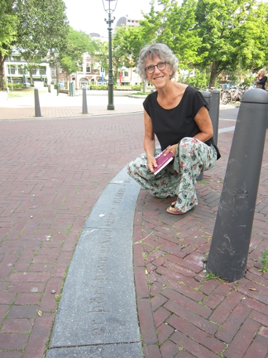 Ingrid Tieken by the kerb with the Icelandic proverb carved into it.