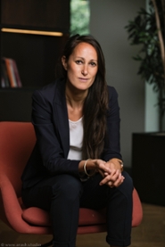 Professor Marieke Liem sits on a chair and looks at the camera.