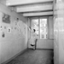 Truus Wijsmuller, board member of the Anne Frank Stichting, removes the plastic covering the pictures in Anne's room before the official opening of the museum. Amsterdam, 3 May 1960.