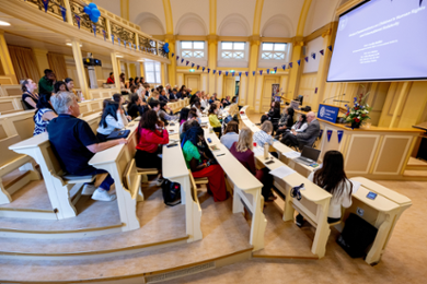 Attendees sit in the Lorentzzaal listening to a panel discussion for the anniversary of the International Children's Rights programme.