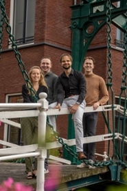 The 2023-2024 Board of LUDev posing on a bridge in Leiden