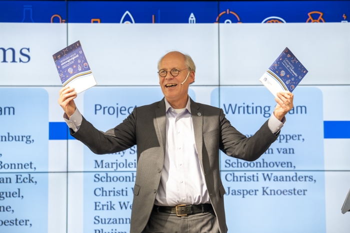 A proud dean shows the booklet.