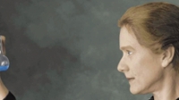 Susan Marie Frontczak portraying Marie Curie on stage