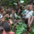 A BaYaka group of women and girls singing and clapping enthusiastically while resting during a hectic day’s work in the forest