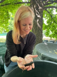 Kat Stewart holding a crested newt in her hands